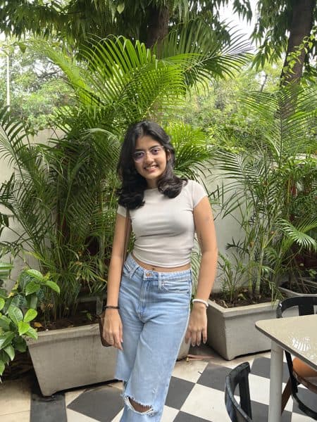 Yanshie standing among greenery